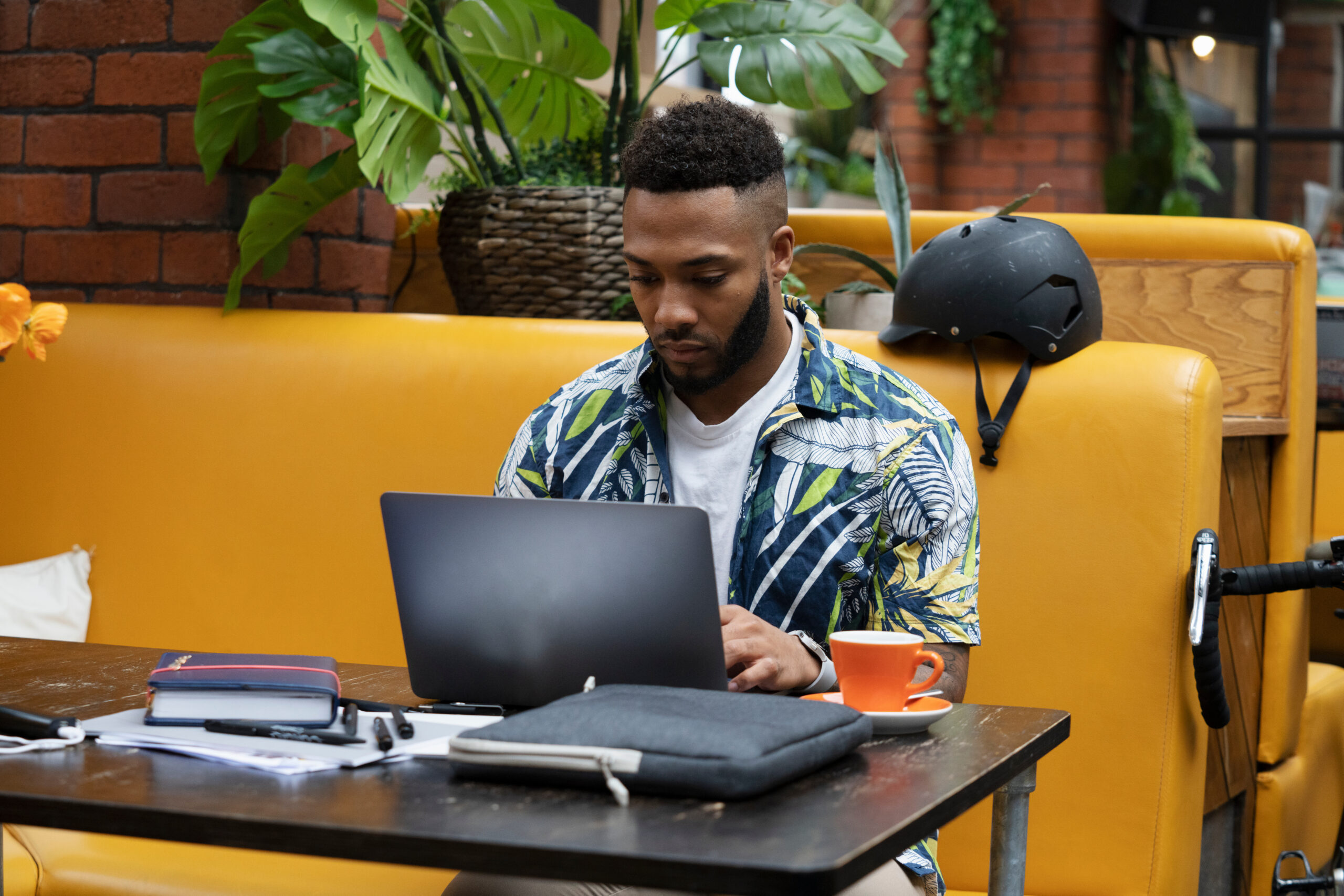 Man sitting in office lounge using laptop